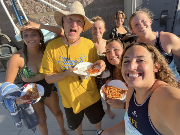 Mr. Reichert having a pizza party with the Water Polo team.